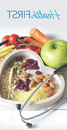 Fruits, vegetables, and nuts in a heart shaped bowl with stethoscope